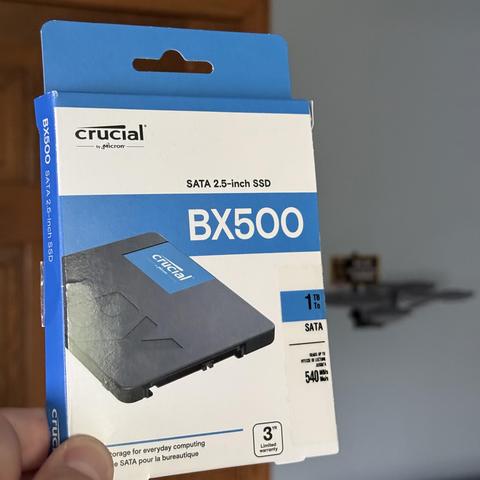 A 2.5” SATA SSD drive in box, 500GB Crucial with 1TB storage and read speeds up to 540 MB/s. BX500 model.
