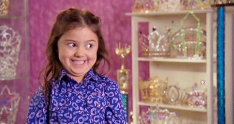 A girl sporting a happy grin, pretty sure it’s from Kids Baking Championship or something similar.
